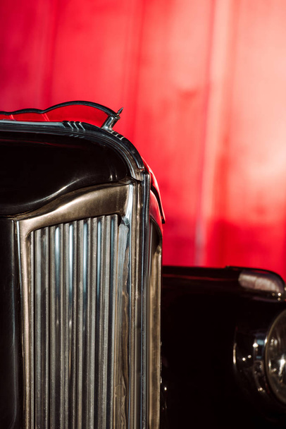 close up of black retro car on red  - Zdjęcie, obraz