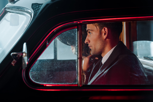 side view of man sitting in retro car  - Photo, Image