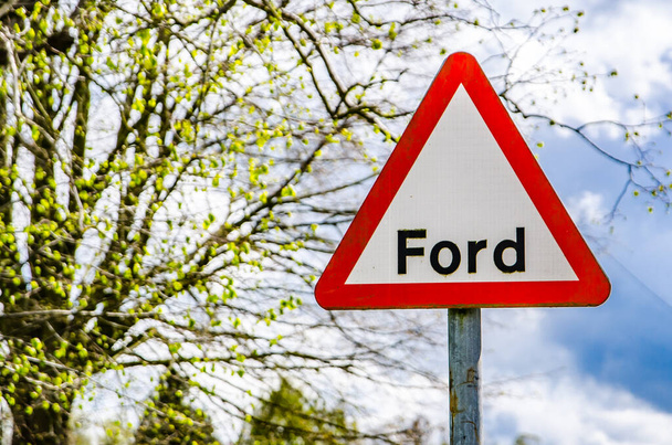 Britannico cartello stradale triangolare che mostra la parola Ford sullo sfondo primavera
. - Foto, immagini