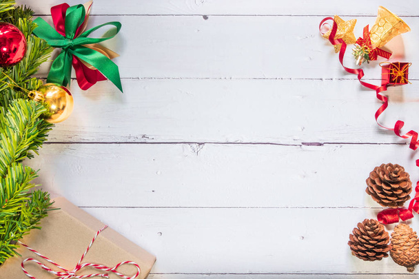 Christmas composition festive background. Christmas decorations and xmas gift boxes on wooden white table. Celebration for holiday concept, New Year, winter. Flat lay, top view with copy space - Photo, Image