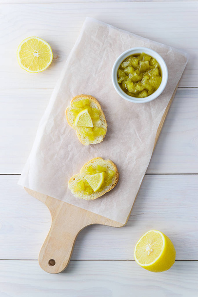 Cucumber jam with lemon on a wooden board. Vertical orientation, top view. - Fotoğraf, Görsel