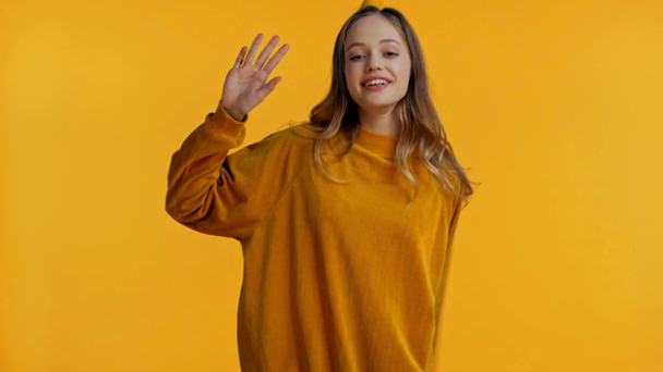 smiling teenager dancing isolated on yellow - Footage, Video