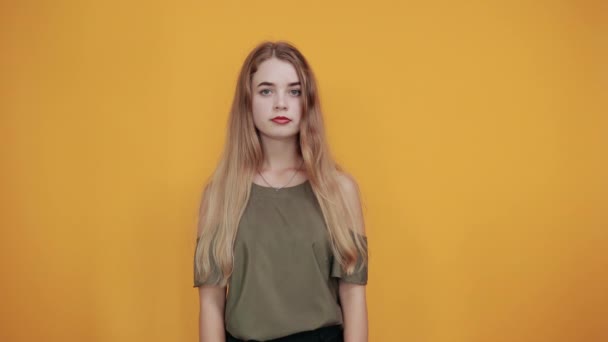 Portrait of worried young woman looking directly, holding hands crossed, praying - Video