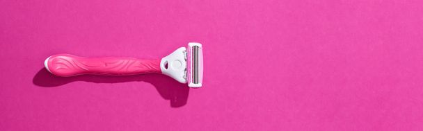 top view of female razor on pink background, panoramic shot - Photo, image