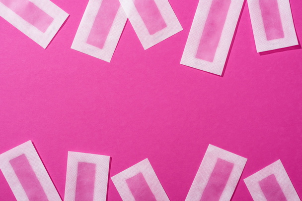 top view of wax depilation stripes on pink background - Zdjęcie, obraz