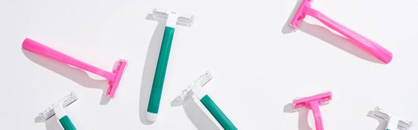 top view of female pink and green disposable razors on white background, panoramic shot - Photo, Image