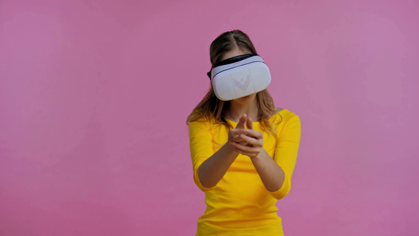 teenager throwing with virtual reality headset isolated on pink - Materiaali, video