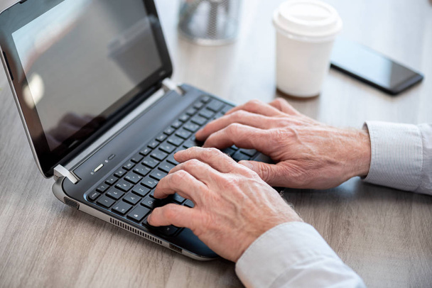 Hands typing on laptop keyboard - Photo, Image
