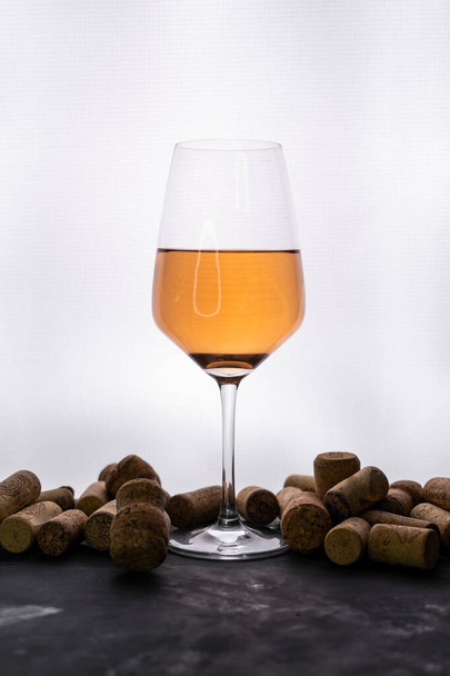 a glass of orange wine with bottle caps - Photo, Image