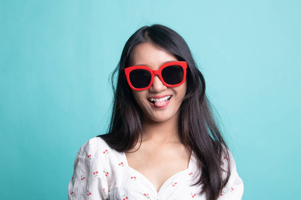 Portrait of a beautiful young asian girl in sunglasses. - Photo, Image
