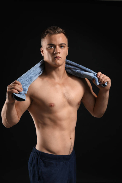 Handsome male bodybuilder on dark background - Foto, Imagem