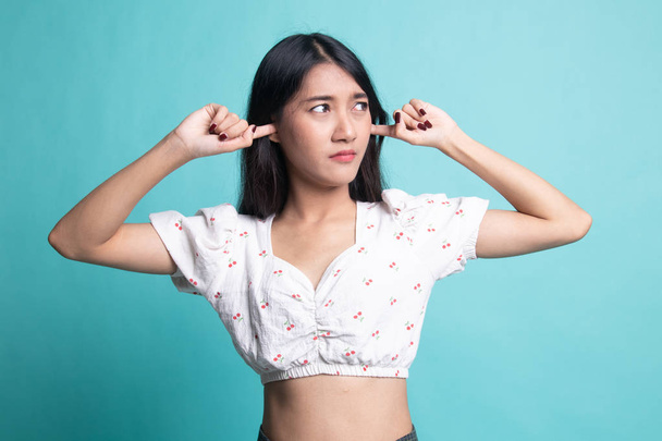 Young Asian woman block both ears with fingers . - 写真・画像