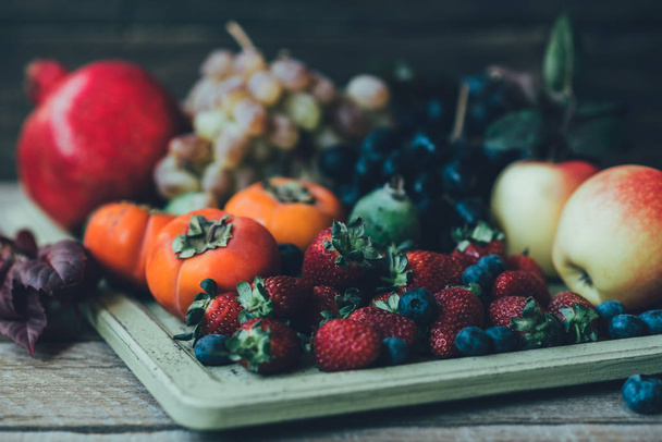 Fresh fruits. Assorted fruits colorful background. Organic food. Fresh raw fruits and berries. Autumn harvest. Toned image. Soft focus. - Foto, imagen