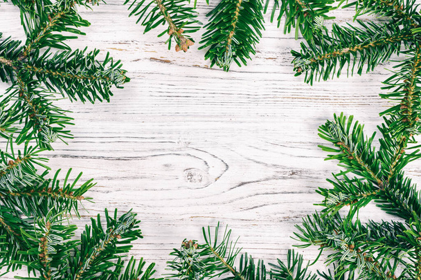 Christmas fir tree on a wooden background top view with copy space for you design. Toned - 写真・画像