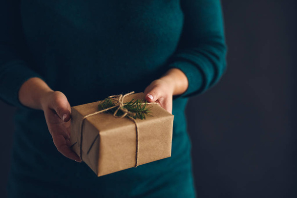 Woman holding wrapped Christmas present with copy space - Fotografie, Obrázek