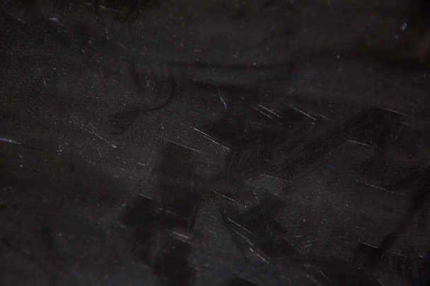 Witte vlekken op zwart glas voor textuur en design - Foto, afbeelding