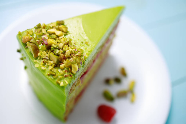 Cake with fruity cream and pistachio decorated with nuts, isolate - Photo, Image