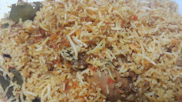 A close up  view of cooked rice chicken biryani made with traditional recipe  - Photo, Image