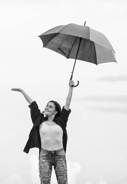 Pretty woman with colorful umbrella. Rainbow umbrella. Rainy weather. Good mood. Good vibes. Open minded person. Girl feeling good sky background. Easy and free. Good weather. Welcoming fall - Фото, изображение