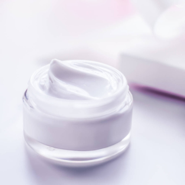 Facial cream moisturizer jar on holiday glitter background, mois - Fotó, kép