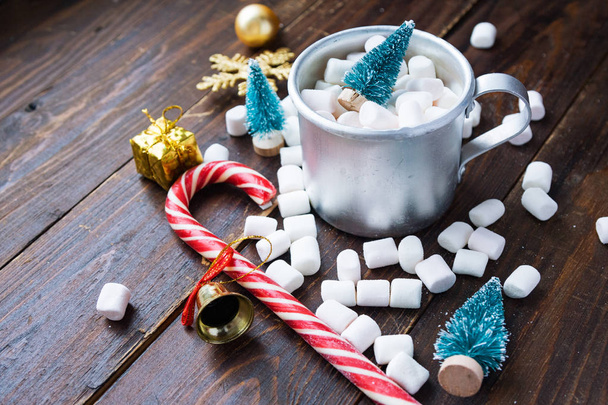 Christmas marshmallows and new year decorations on wood background. Winter holidays, New Year mood - Fotó, kép