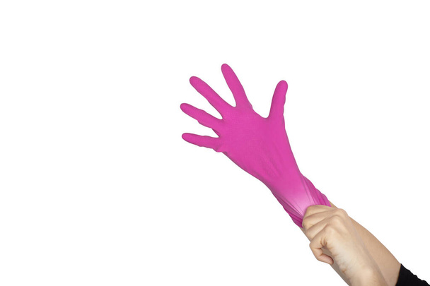 La mano femenina lleva un guante protector para limpiar u ordenar
 - Foto, Imagen