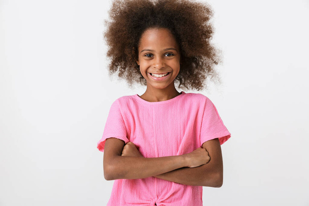 Cheerful little african girl wearing pink blouse standing - Foto, Imagen