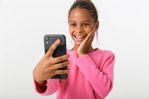 Image of excited african american girl taking video call on cellphone - Valokuva, kuva
