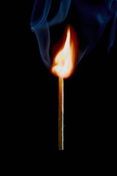 Safety match on black background with flaming head - 写真・画像