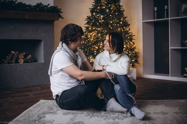 woman and man enjoying perfect relationships and spending winter vacations in cozy home interior - Fotografie, Obrázek