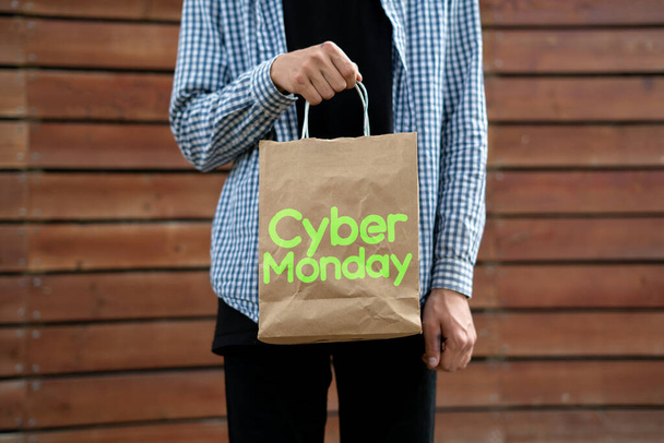 person holding bag with some new gadgets bought on the cyber monday - Fotó, kép