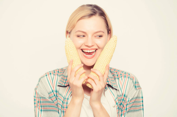 Corn harvest. Girl hold ripe corn. Food vegetarian and healthy natural organic products. Vegetarian menu. Healthy food concept. Food bring happiness. Woman hold yellow corn cob white background - Φωτογραφία, εικόνα