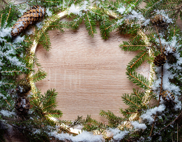 Christmas round frame made by neon and winter things on wood background. - Фото, изображение