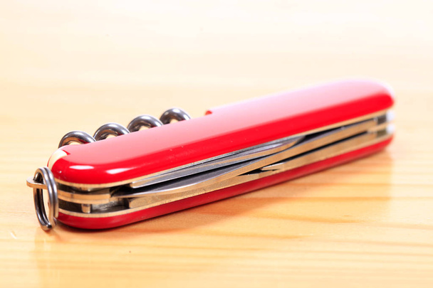 Swiss knife on a wooden background - Photo, Image