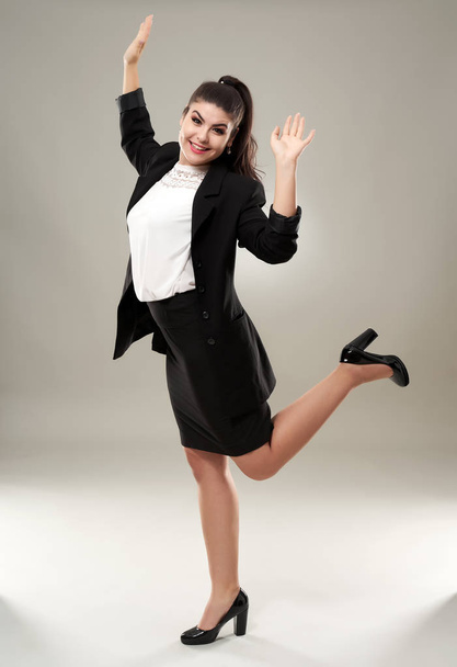Cheerful young latin businesswoman, full length on gray background - Foto, immagini