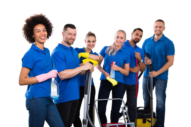 Smiling Multiethnic Group Of Janitors Wearing Blue T-shirt Standing Grouped Together With Their Equipment - Fotografie, Obrázek
