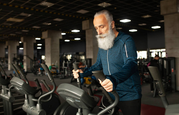 Bearded Senior Man On Running Machine In Gym. Treadmill.  - Фото, зображення