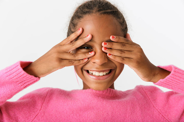 Image closeup of funny african american girl smiling and peeping - Fotó, kép