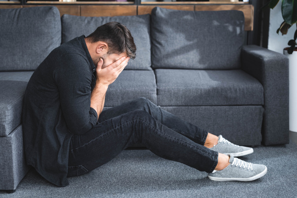 side view of man with panic attack crying in apartment  - Photo, Image