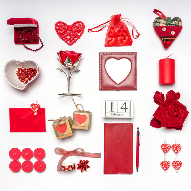 Stylish accessories, decorative items and miniature toys in red color on white background. Calendar date February 14, greeting card for Valentine's day. Love and romance concept. Copy space, mock up - Photo, Image