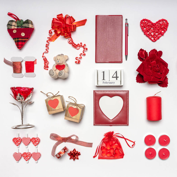Stylish accessories, decorative items and miniature toys in red color on white background. Calendar date February 14, greeting card for Valentine's day. Love and romance concept. Copy space, mock up - Foto, Bild