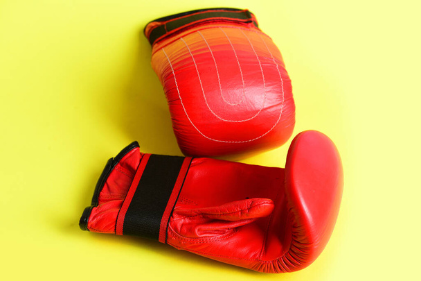 Mittens for boxing in red color isolated on yellow background - Foto, Bild