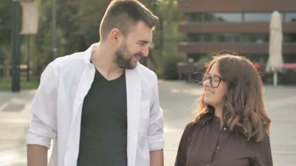 Young Attractive Couple Walking in the Street at Sunset. Trendy Woman Smiling Happily. Looking Excited. - Footage, Video