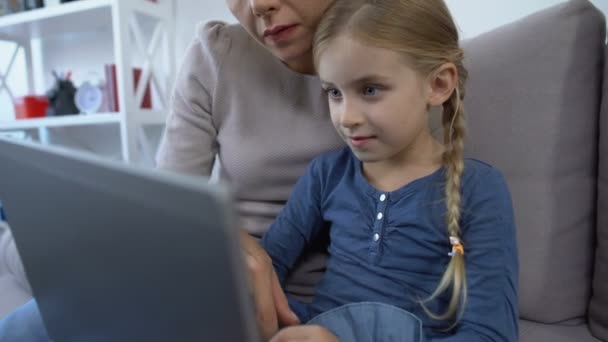 Little girl and mother making videocall on tablet pc, waving hands on camera - Кадри, відео