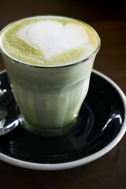 Gorąca zielona herbata latte na drewnianym blatem - Zdjęcie, obraz