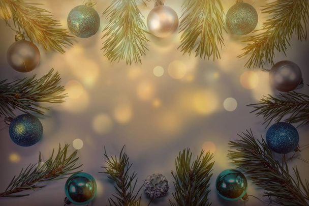 Christmas background with pine branches, bright balls and golden bokeh. Holiday concept. View from above. - Photo, Image