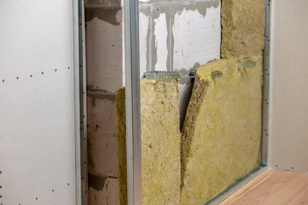 Wall of a room under renovation with mineral rock wool insulatio - Photo, Image