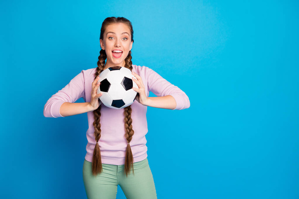Portrait of positive funny youth girl feel enthusiastic hold foot ball want throw support her team on final championship game wear modern outfit isolated over bright color background - Fotó, kép