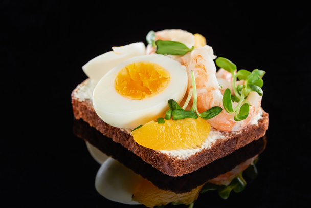 Nahaufnahme von Roggenbrot mit leckeren Garnelen auf Smorrebrod Sandwich auf Schwarz  - Foto, Bild
