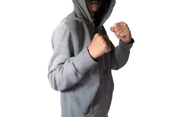 Šedý kapuce bunda muž v boxerské ochranný akce se stínem s selektivním ostřením, izolované na bílém pozadí. - Fotografie, Obrázek